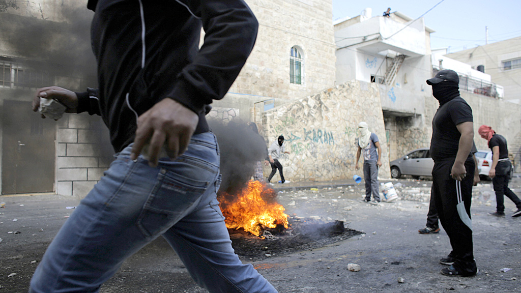 Palestinians during clashes with Israeli police in the Abu Tor neighbourhood of east Jerusalem (Reuters)