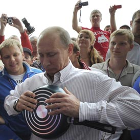 Russian Prime Minister Vladimir Puting attempts to bend a frying pan (Reuters)