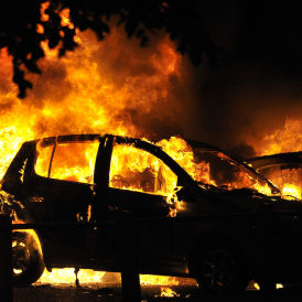 Riots erupt across Britain - a car burns in Ealing (Reuters)