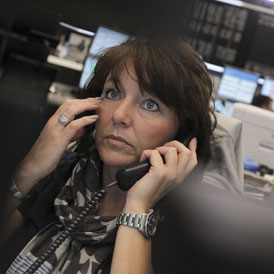 A trader reacts at her desk at the Frankfurt stock exchange (Reuters)