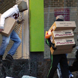 Birmingham riots: youths take hi-fi equipment during looting. (Reuters)