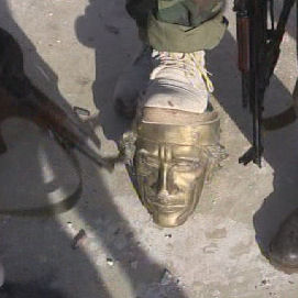Gaddafi statue attacked by rebels.
