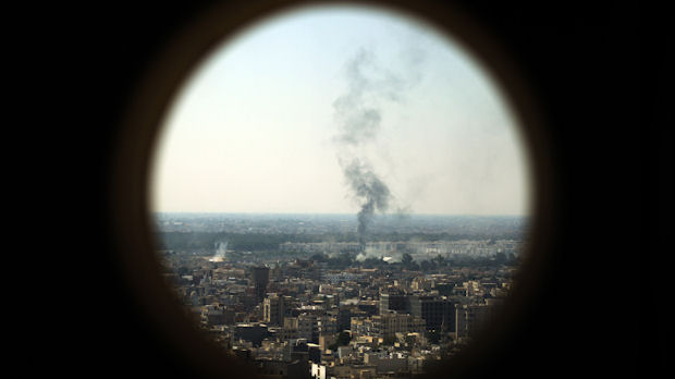 Smoke billows from the Bab al-Aziziya compound - formerly Gaddafi's stronghold - in Tripoli (Reuters)
