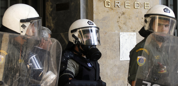 Riot policemen stand guard outside Greece's central bank during a 24-hour general strike in Athens, Greece on 5 October 2011 (Getty)