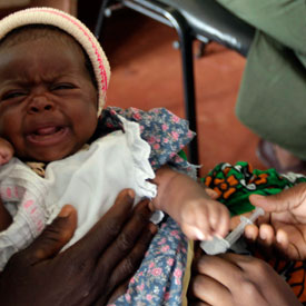 Child being given a vaccine (Reuters)