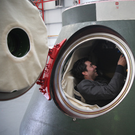 Al Thomson trying out the Russian space capsule (Morland Sanders)