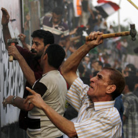 Demonstrators used hammers, large iron bars and police barricades to tear down the wall, which was erected this month by the Egyptian authorities.