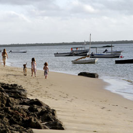 Tourists walk along the beach at Kiwayu Safari Village, where British holidaymaker David Tebbutt was killed and his wife Judith kidnapped (Reuters)