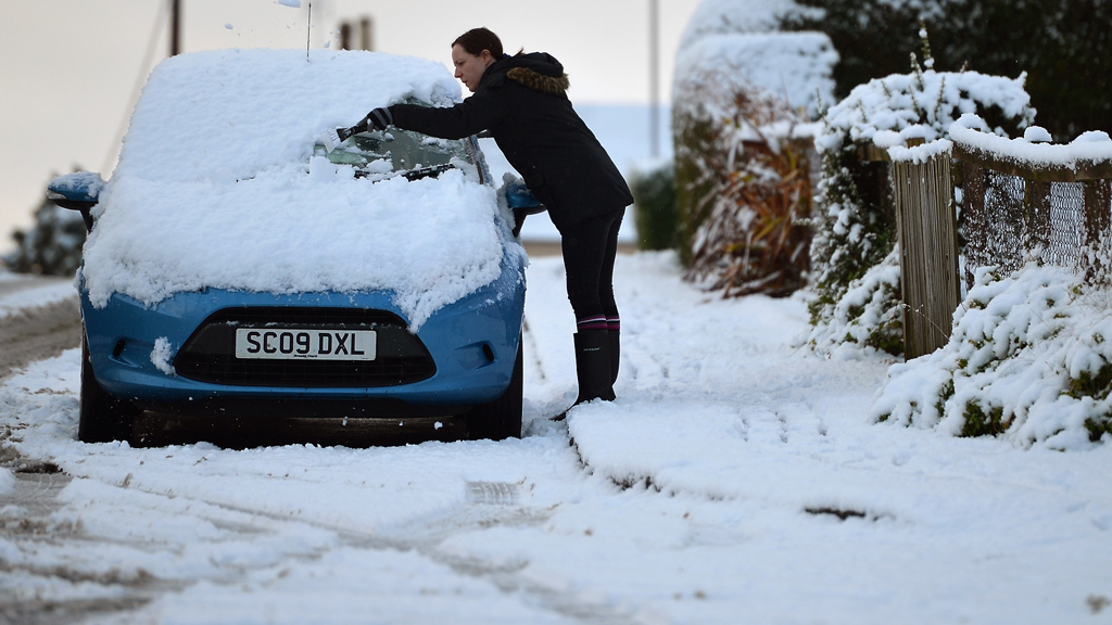 A woman clears her car from snow in Banockburn on December 3, 2012 in Banockburn, Scotland (Getty)