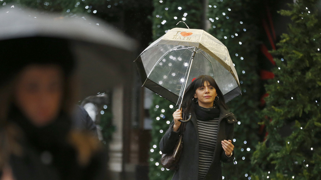 A woman shopping under an umbrella. (Reuters)