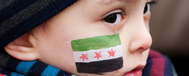 A child with a painted face sits with his mother during a protest against Bashar al-Assad's regime's crackdown on pro-democracy protests, outside the Syrian embassy in central London (Getty)