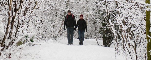 Two people walk through the snow-laden footpaths of Alexandra Park, north London (Getty)