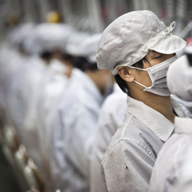Chinese workers on an Apple assembly line at a Foxconn factory in China. (Getty)