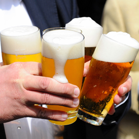 Man holding four beer glasses in two hands (Getty)