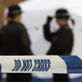 Police women stand on duty near a tent covering the murder scene in Leytonstone in April 2007 (Getty)