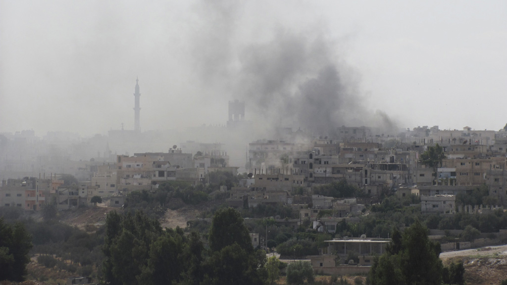 Smoke rises over Deraa (Reuters)