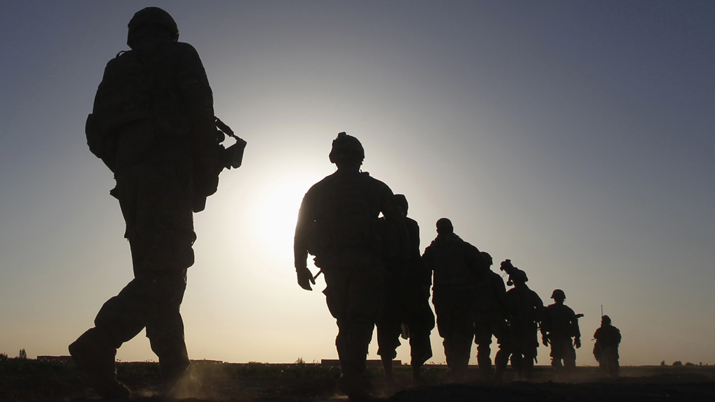 U.S. Army soldiers are silhouetted as they walk during a mission in the Maiwand district of Kandahar province, southern Afghanistan (Reuters)