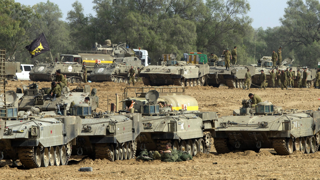 Israeli armoured personnel carriers near the border with the gaza strip (Getty)