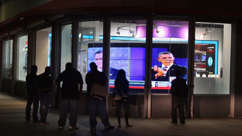 Crowd watching debate on TV through a window (getty)