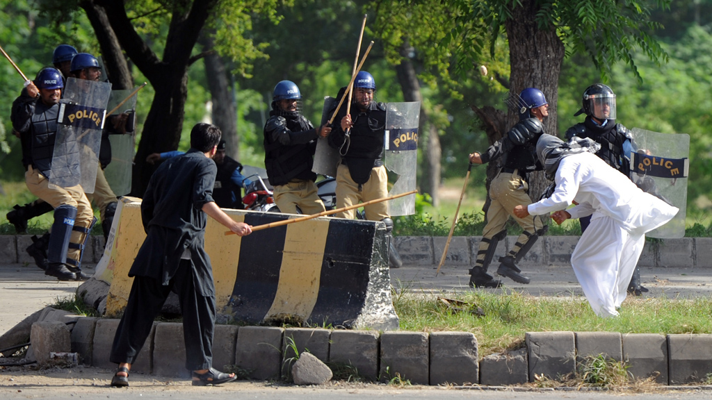 Pakistani riot police charge a demonstrator attempting to reach the US embassy during a protest against an anti-Islam film in Islamabad (Getty)