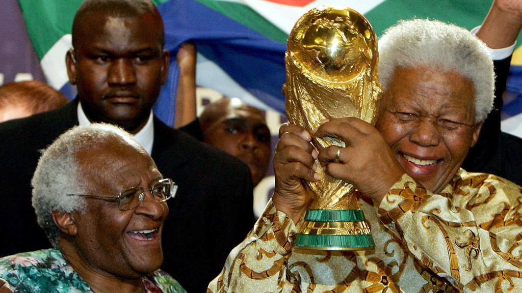 Archbishop Desmond Tutu with Nelson Mandela holding the World Cup in 2004