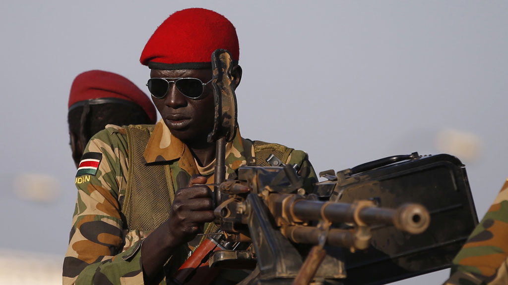 SPLA soldiers stand in a vehicle in Juba, South Sudan (R)