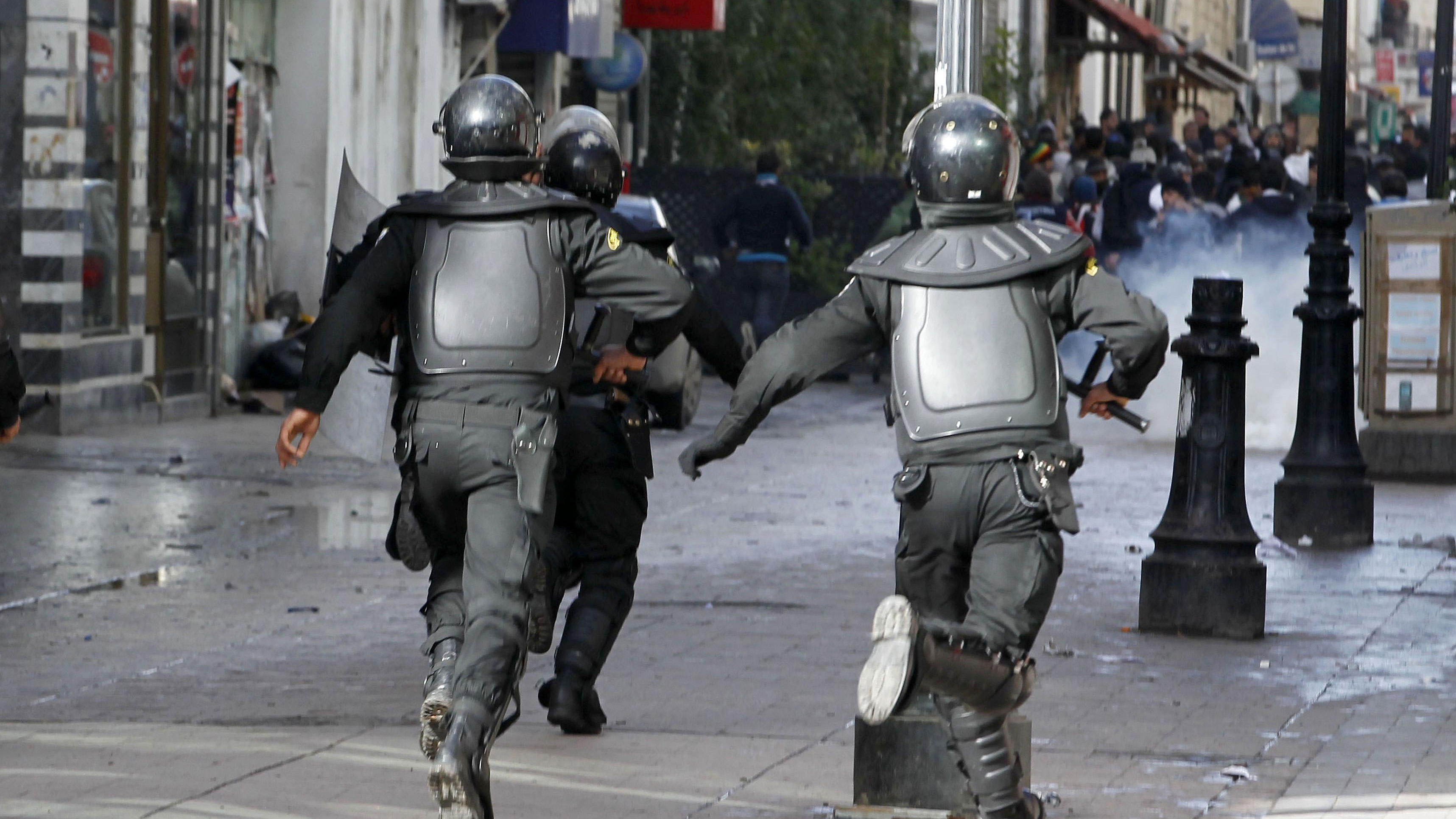 Riot police run at protestors in Tunisia (Reuters)