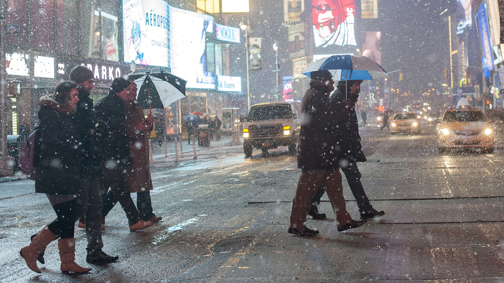 Shoppers brave the snow in Times Square, New York (Reuters)