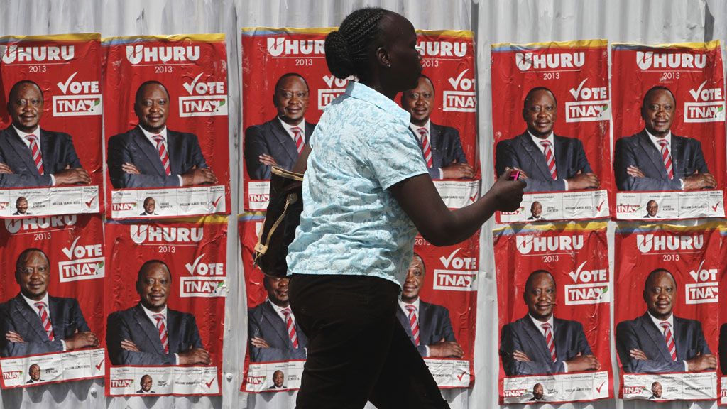A woman walks by posters of Kenya's deputy prime minister Uhuru Kenyatta in Nairobi (pic: Reuters)