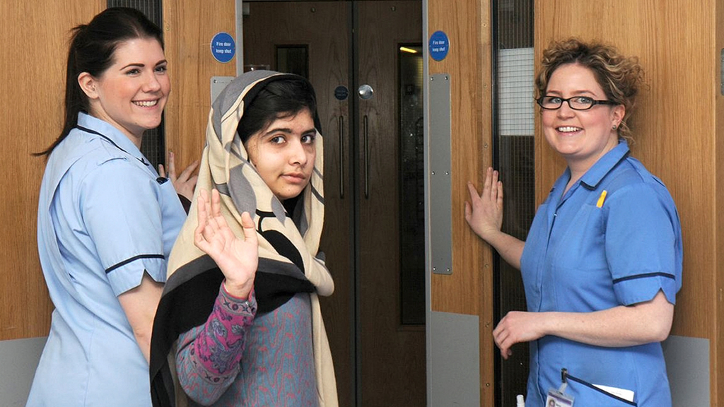 Malala Yousafzai waves as she leaves Birmingham's Queen Elizabeth Hospital (Reuters)