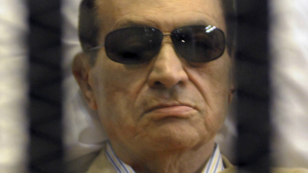 Egypt's former leader Hosni Mubarak behind bars in a courtroom (Reuters)