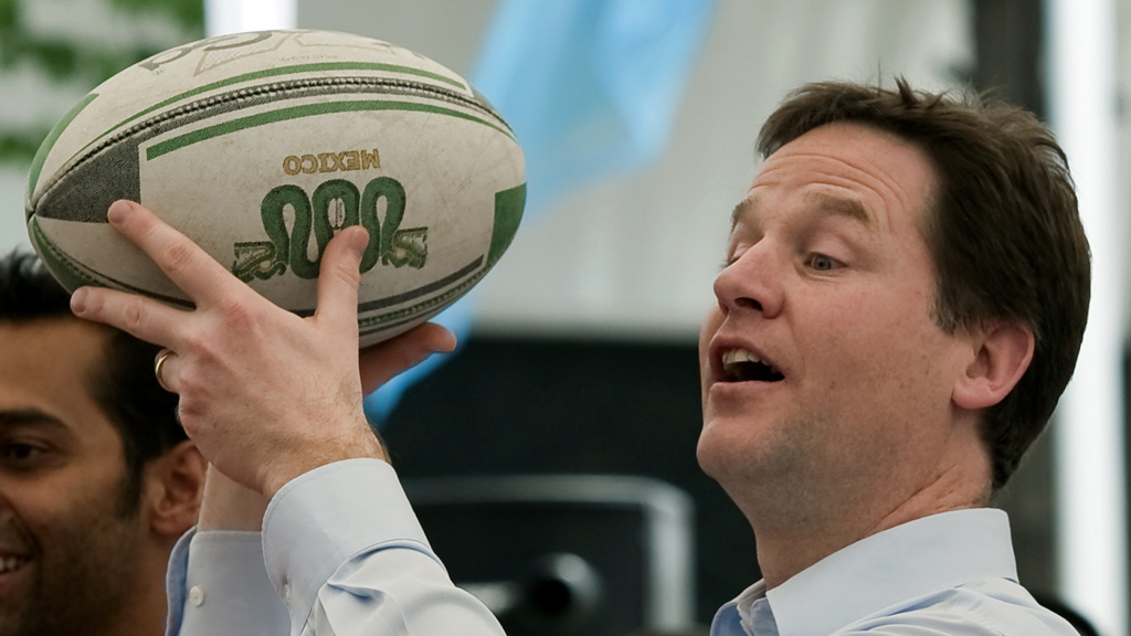Nick Clegg chucks a rugby ball. (Getty)