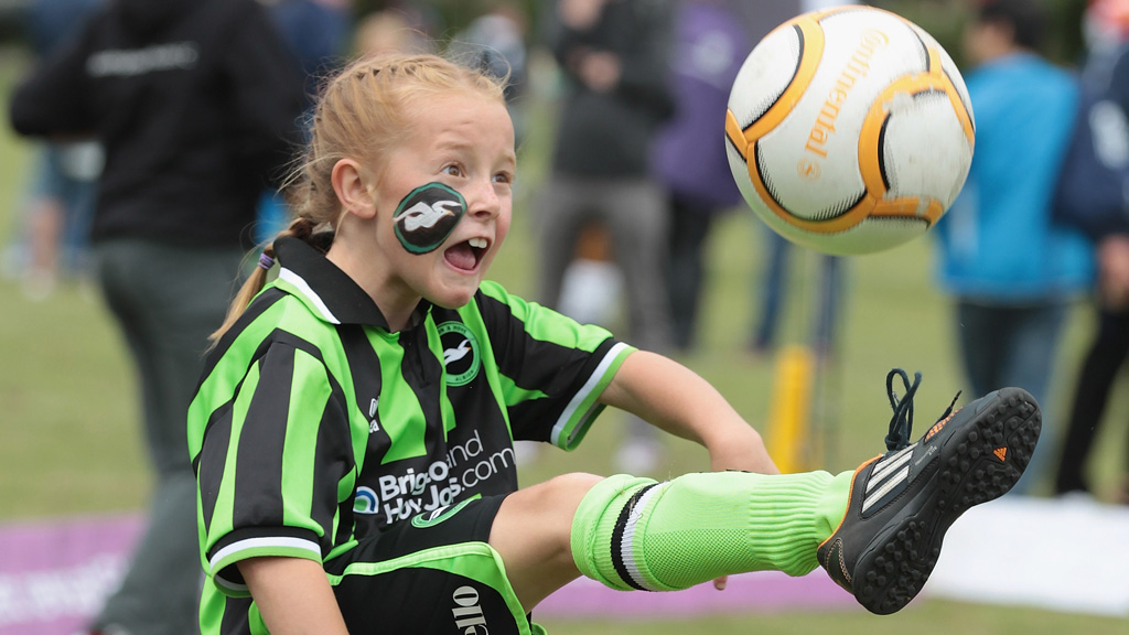 A girl kicks a ball during the FA Girl's Football Festival at Preston Park in Brighton, June 2013. (Getty)
