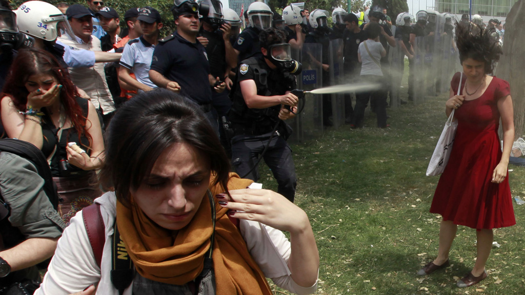 Police fire teargas at a woman in Taksim Square, Turkey, as protestors gather to protect a park from redevelopment (picture: Reuters)