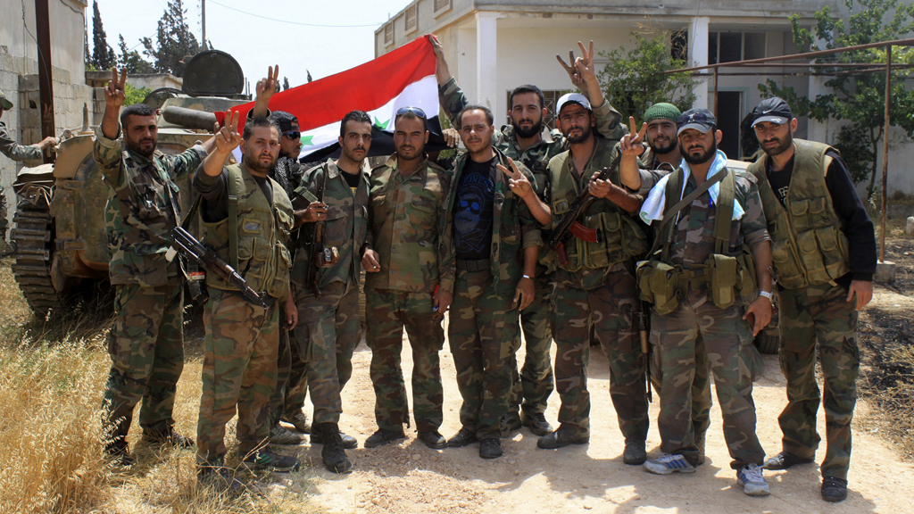Syrian government soldiers in the town of Debaa, near Qusayr, which they captured with help from Hezbollah (pictures: Reuters)