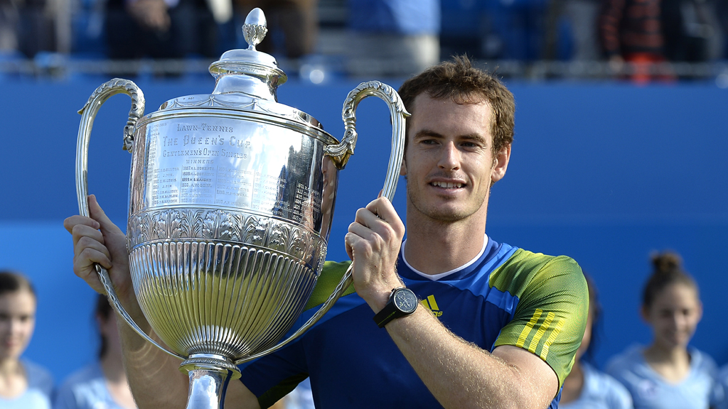 Andy Murray lifts the trophy at Queen's Club, London, after his 2013 win. 