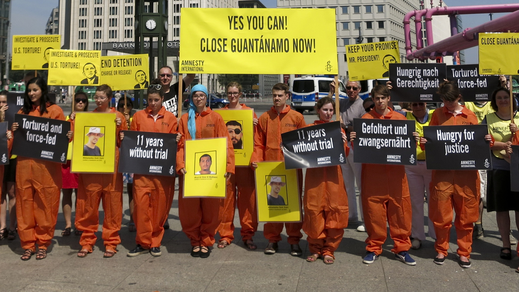 Protests aimed at Barack Obama's Berlin visit included one by Amnesty International activists over the continued detention of suspects at Guantanamo Bay (picture: Reuters)