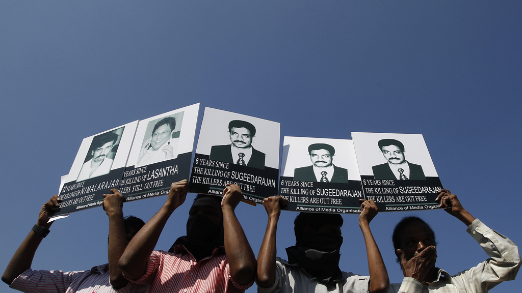 Members of the Alliance of Media Organisation protest holding placards of missing journalists in Colombo (R)