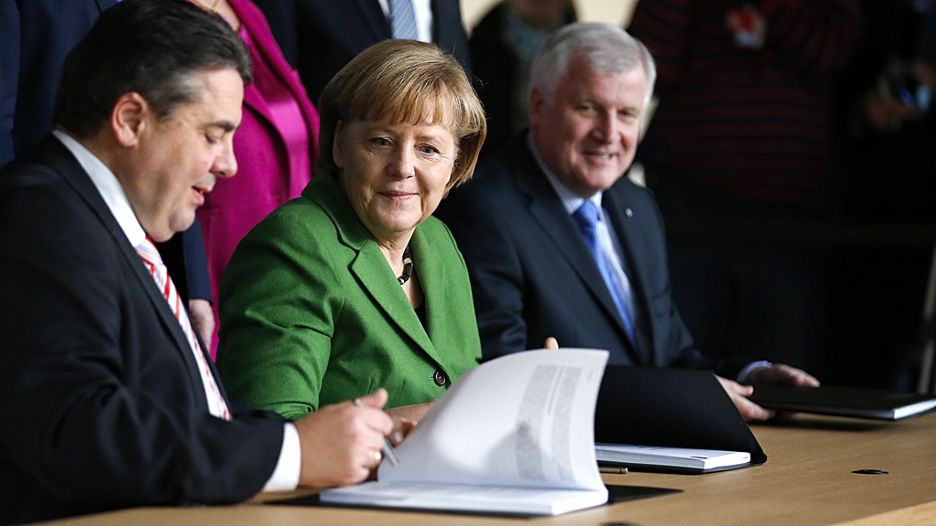Germany's 'grand coalition' document is signed by Angela Merkel (Image: Reuters)