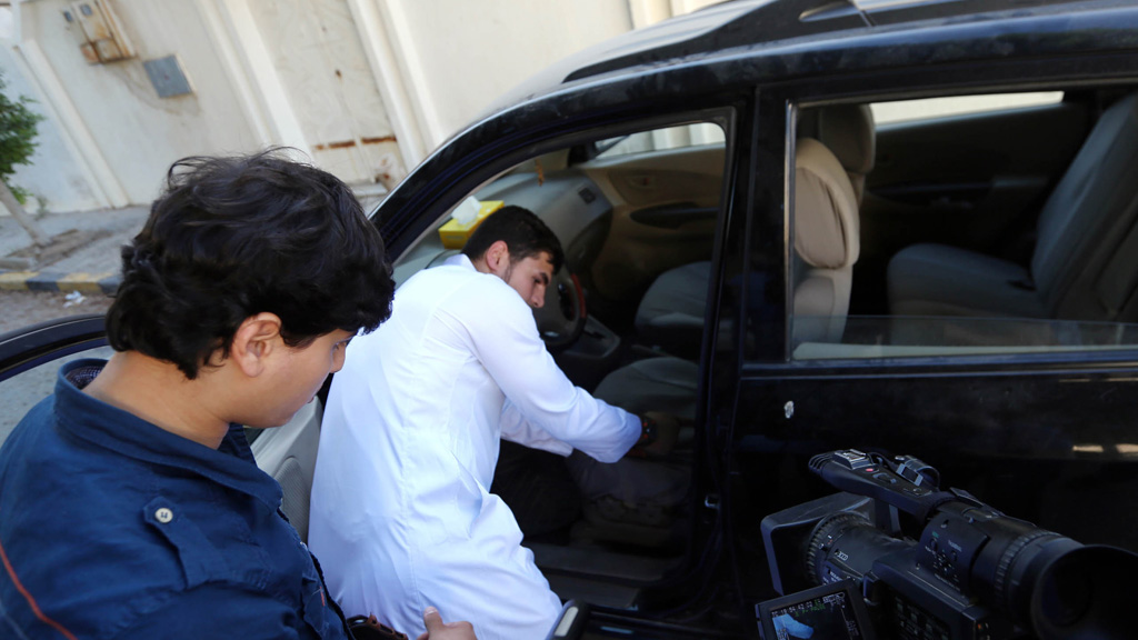 Al-Libi's son shows reporters the car that the suspected al-Qaeda operative was taken from (picture: Getty)