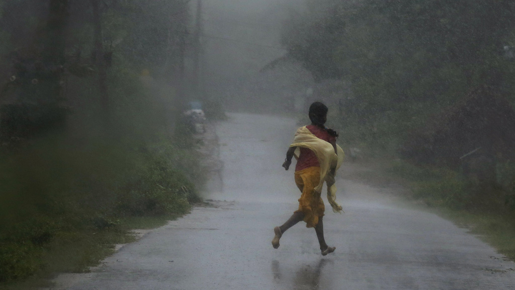 Villager runs for shelter (Reuters)