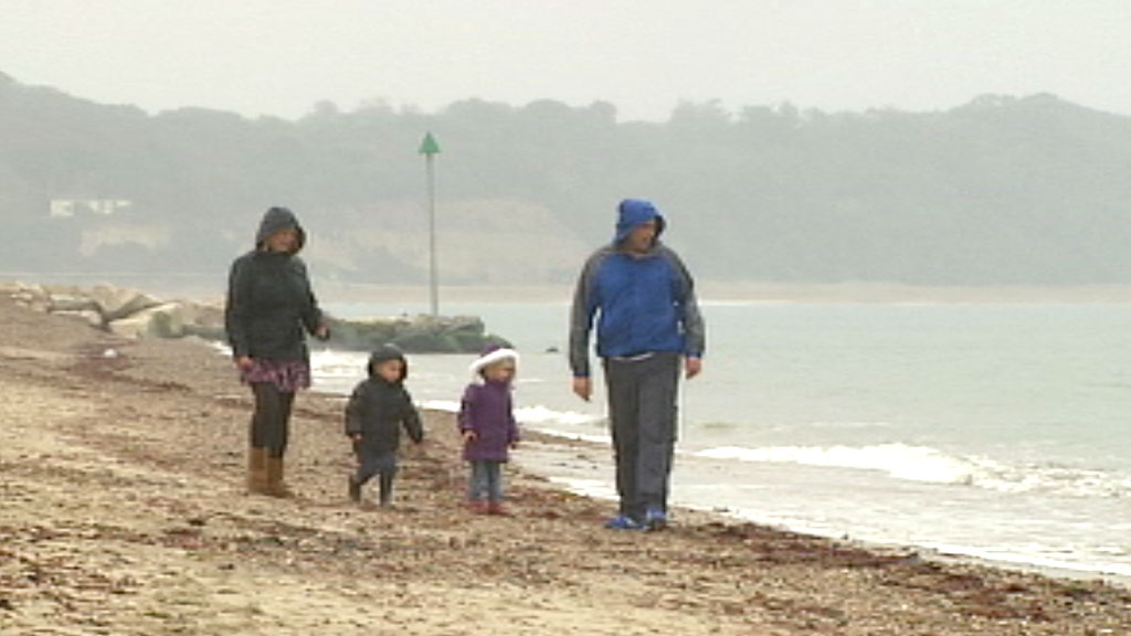 Karen and Gary Marquick, with their two children, on a Dorset beach