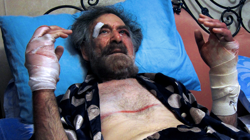Syrian cartoonist Ali Ferzat in hospital after being beaten up in 2011 (picture: Getty)