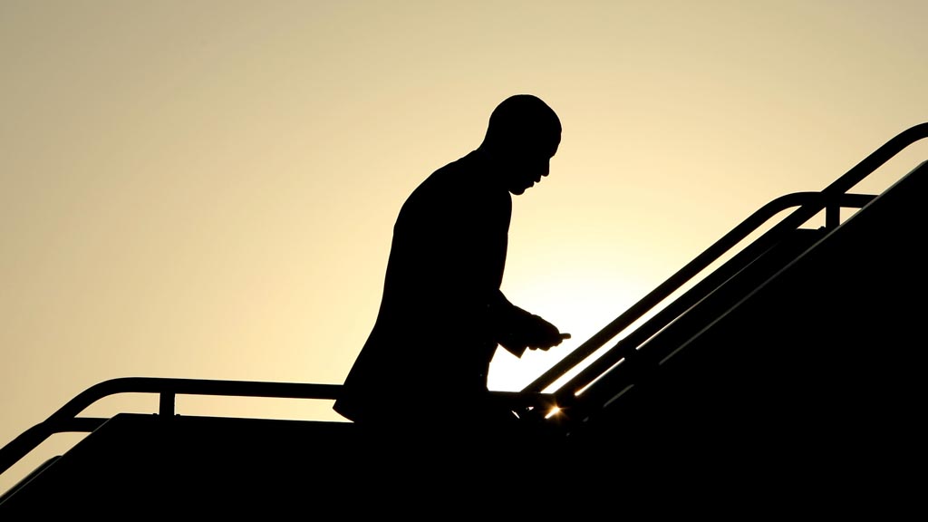 Barack Obama in silhouette boarding a plane. (Getty)