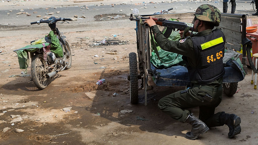 A Cambodian military police officer aims his assault rifle (picture: Getty)
