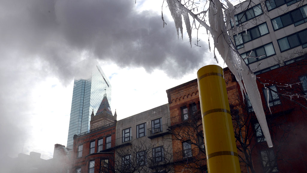 Boston's John Hancock Tower is seen through the smoke, as temperature drop in Massachusetts (R)