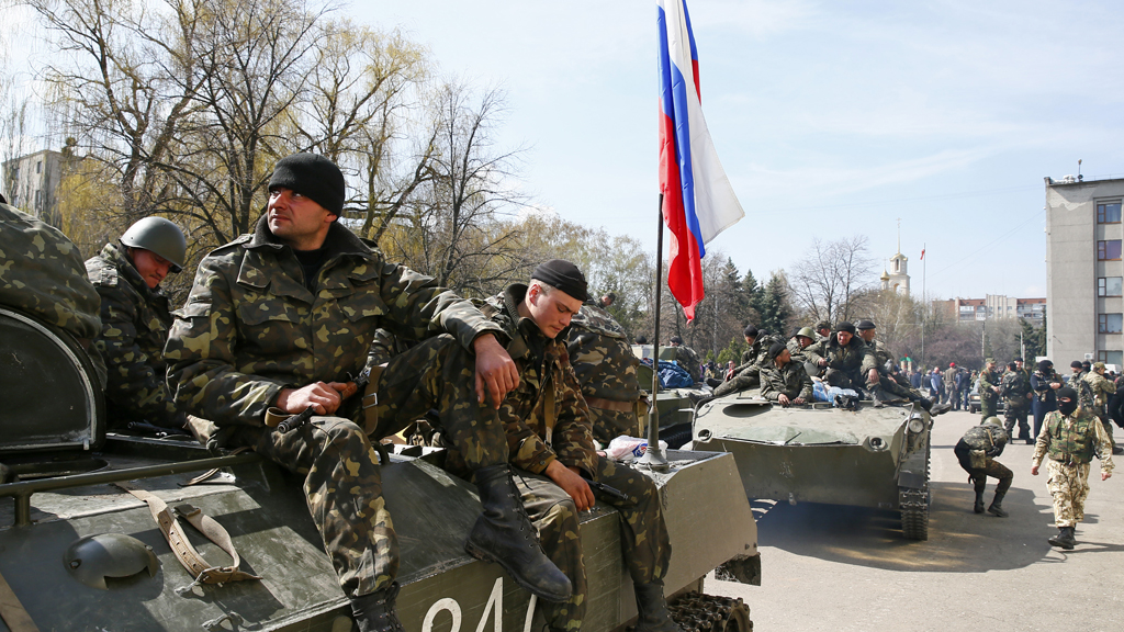 The tension between Russia and Ukraine increases as armed men presumed to be pro-Russian activists enter the town of Slaviansk in troop carriers (Reuters)