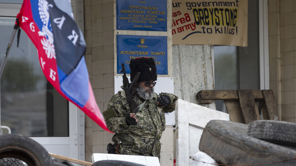 Pro-Russian armed men stand guard outside a regional government building seized by them in Kramatorsk, eastern Ukraine (Reuters)