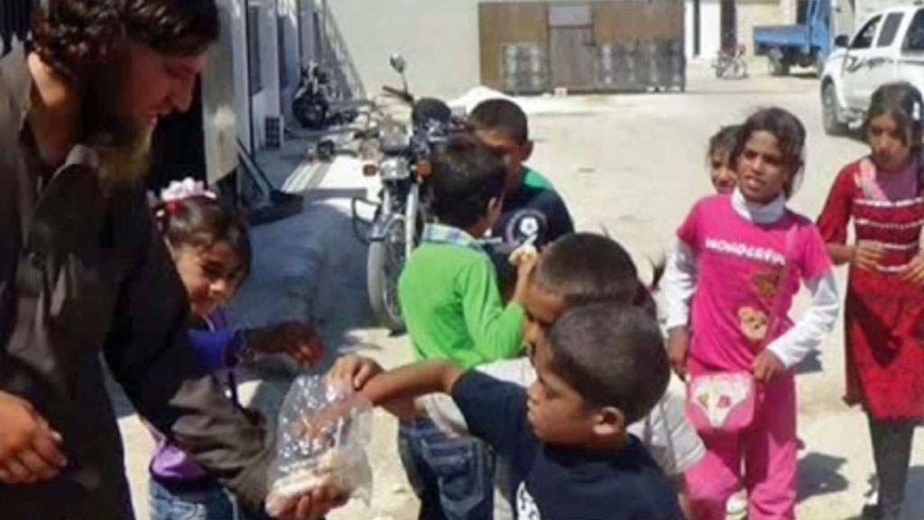 Isis insurgent hands outs sweets to children