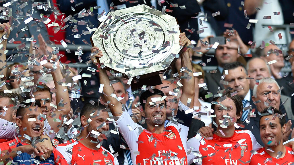 Arsenal players celebrate winning the 2014 Community Shield (Getty)